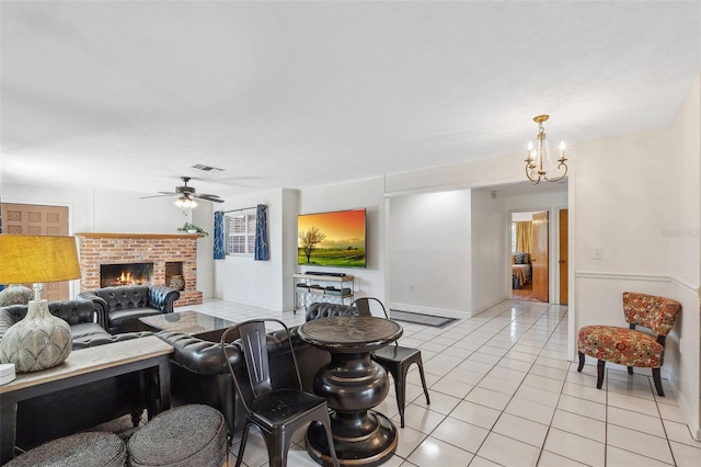 102 Lake Ring Dr, Winter Haven, FL 33884 - living room featuring light tile patterned floors, visible vents, ceiling fan with notable chandelier, and a brick fireplace