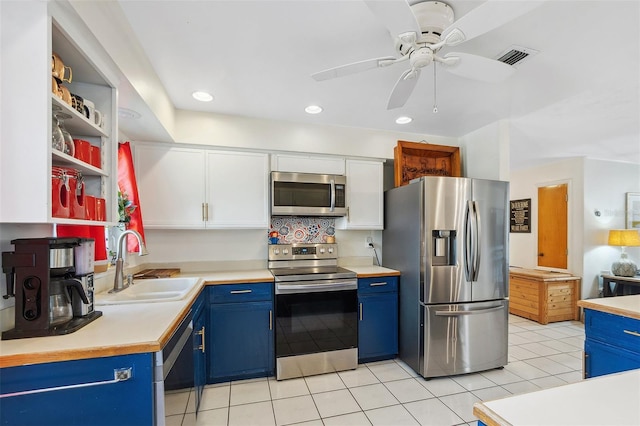 102 Lake Ring Dr, Winter Haven, FL 33884 - kitchen featuring light countertops, appliances with stainless steel finishes, blue cabinets, and a sink