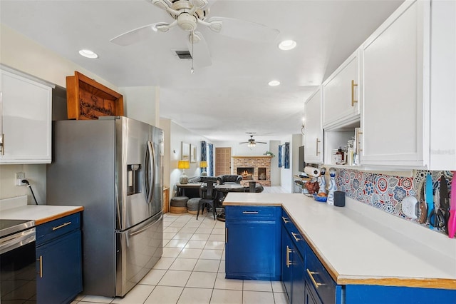 102 Lake Ring Dr, Winter Haven, FL 33884 - kitchen featuring stainless steel fridge with ice dispenser, blue cabinets, and ceiling fan