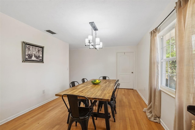 102 Lake Ring Dr, Winter Haven, FL 33884 - dining area featuring visible vents, baseboards, light wood-type flooring, and a chandelier