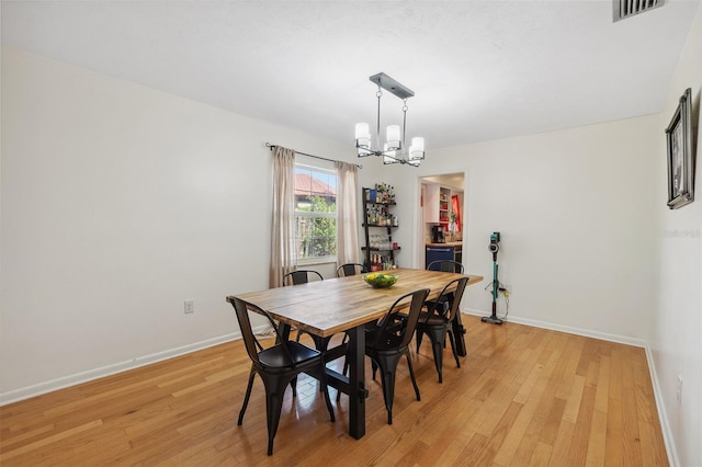 102 Lake Ring Dr, Winter Haven, FL 33884 - dining space featuring a notable chandelier, visible vents, light wood-type flooring, and baseboards