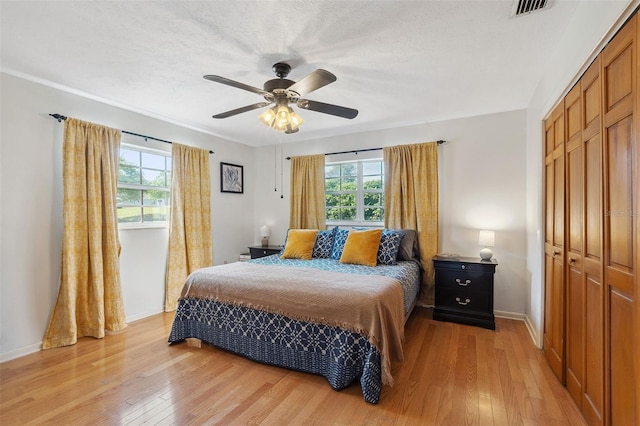 102 Lake Ring Dr, Winter Haven, FL 33884 - bedroom featuring light wood-style flooring, a closet, multiple windows, and visible vents