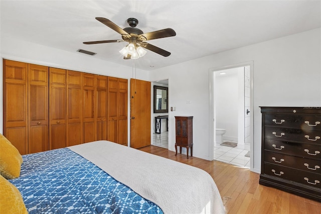 102 Lake Ring Dr, Winter Haven, FL 33884 - bedroom featuring visible vents, a closet, ensuite bathroom, ceiling fan, and light wood-style floors