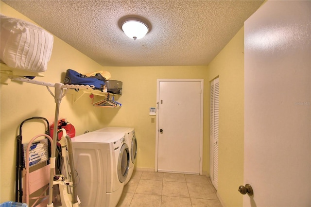 2611 State Road 557, Lake Alfred, FL 33850 - washroom featuring light tile patterned flooring, separate washer and dryer, laundry area, and a textured ceiling