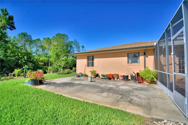 2611 State Road 557, Lake Alfred, FL 33850 - back of property with a lanai, a patio, a yard, and stucco siding