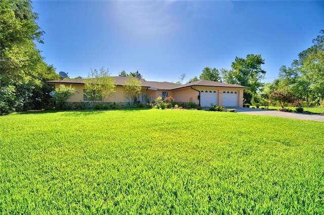 2611 State Road 557, Lake Alfred, FL 33850 - single story home with concrete driveway, stucco siding, a front lawn, and a garage