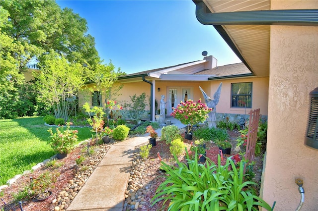 2611 State Road 557, Lake Alfred, FL 33850 - view of exterior entry featuring a lawn and stucco siding