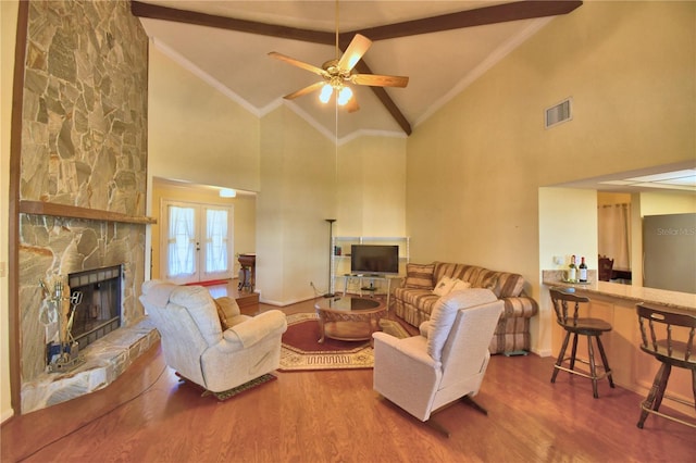 2611 State Road 557, Lake Alfred, FL 33850 - living room with high vaulted ceiling, beamed ceiling, a stone fireplace, visible vents, and wood finished floors