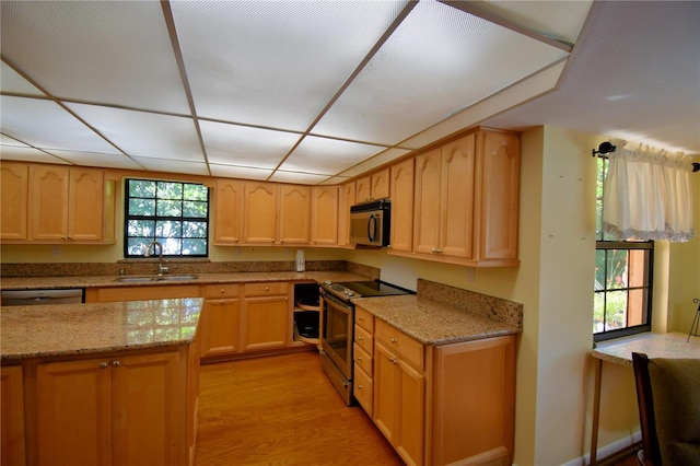 2611 State Road 557, Lake Alfred, FL 33850 - kitchen with light brown cabinets, light stone countertops, light wood-style floors, stainless steel appliances, and a sink