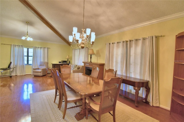 2611 State Road 557, Lake Alfred, FL 33850 - dining room featuring baseboards, ornamental molding, a chandelier, a textured ceiling, and wood finished floors