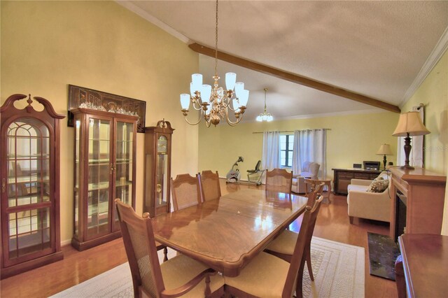 2611 State Road 557, Lake Alfred, FL 33850 - dining space with high vaulted ceiling, a notable chandelier, crown molding, and wood finished floors