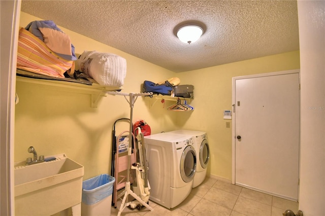 2611 State Road 557, Lake Alfred, FL 33850 - clothes washing area with separate washer and dryer, a sink, laundry area, a textured ceiling, and light tile patterned flooring