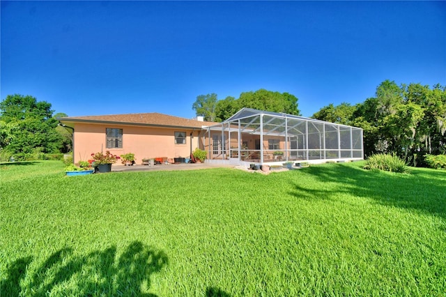 2611 State Road 557, Lake Alfred, FL 33850 - rear view of property with a yard, a patio, stucco siding, and a lanai