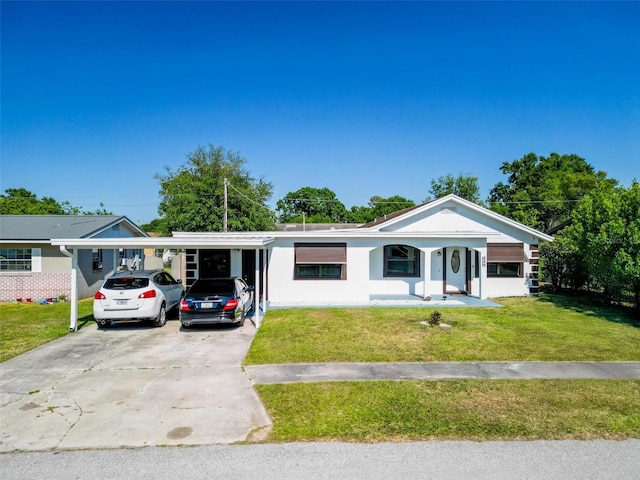 ranch-style home with stucco siding, a carport, a front yard, and concrete driveway