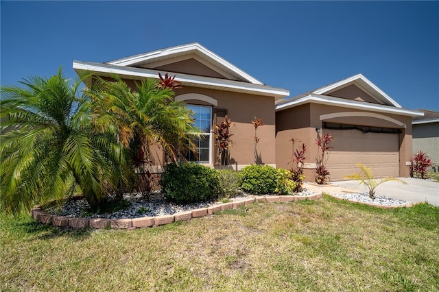 249 Haines Blvd, Winter Haven, FL 33881 - view of front facade with a garage, driveway, stucco siding, and a front lawn