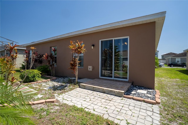249 Haines Blvd, Winter Haven, FL 33881 - back of property featuring a yard, a patio, and stucco siding