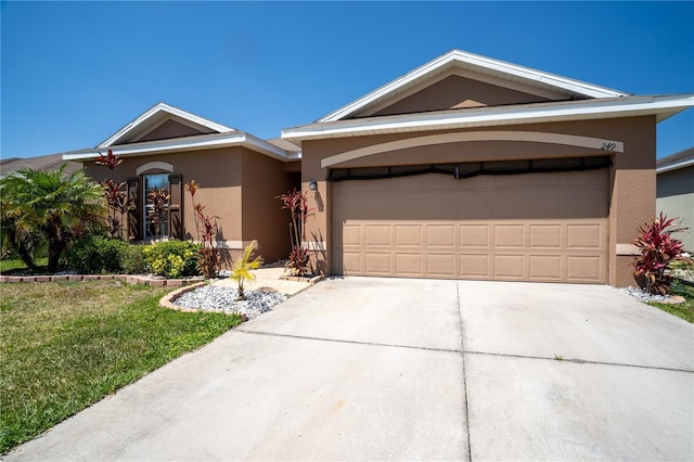 249 Haines Blvd, Winter Haven, FL 33881 - ranch-style house with a garage, a front yard, driveway, and stucco siding