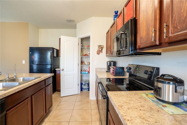 249 Haines Blvd, Winter Haven, FL 33881 - kitchen featuring light countertops, light tile patterned flooring, black appliances, visible vents, and a sink