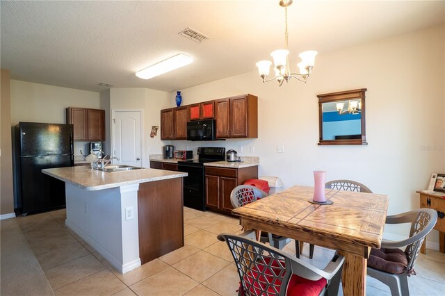 249 Haines Blvd, Winter Haven, FL 33881 - kitchen featuring visible vents, hanging light fixtures, light tile patterned floors, a notable chandelier, and black appliances