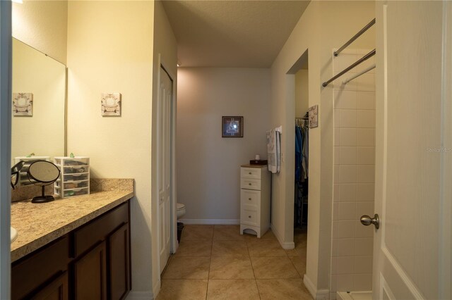 249 Haines Blvd, Winter Haven, FL 33881 - full bathroom featuring vanity, baseboards, tile patterned floors, toilet, and tiled shower