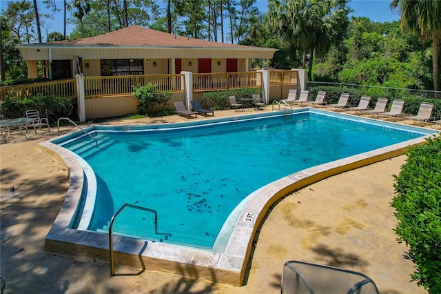 pool featuring a patio area and fence