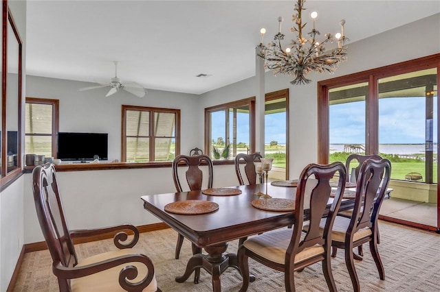 dining room featuring visible vents, ceiling fan with notable chandelier, and baseboards