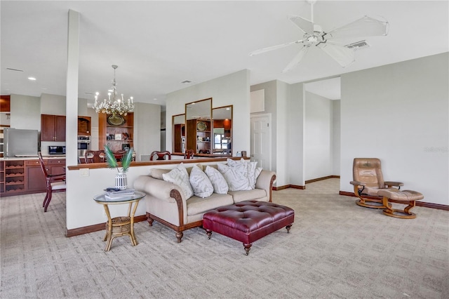 living room with light carpet, ceiling fan with notable chandelier, baseboards, and visible vents