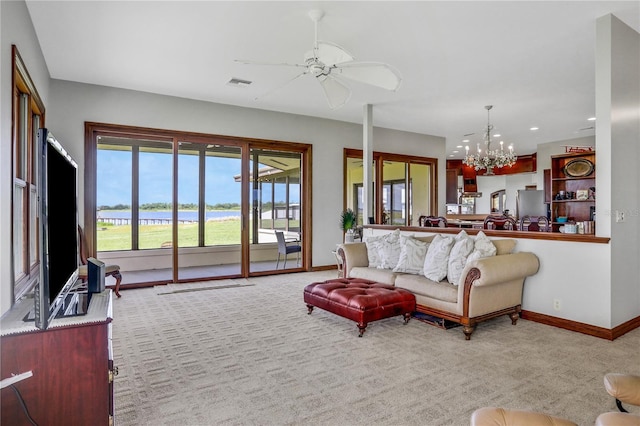 living area with baseboards, recessed lighting, carpet floors, visible vents, and ceiling fan with notable chandelier