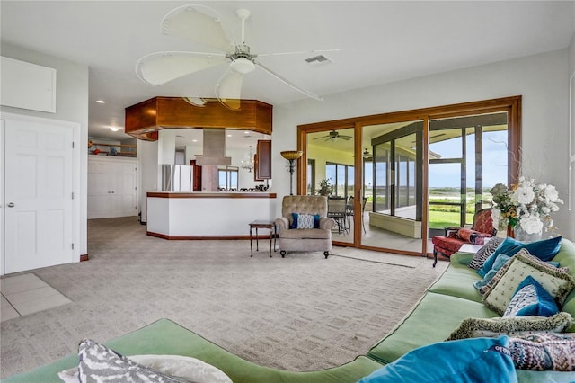 tiled living area with visible vents, baseboards, and a ceiling fan