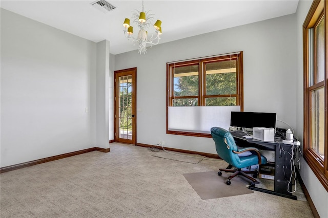 carpeted office space with visible vents, baseboards, and an inviting chandelier