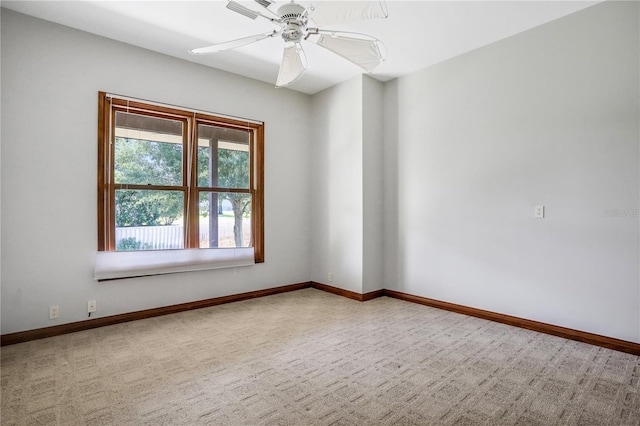 empty room with ceiling fan, carpet flooring, and baseboards