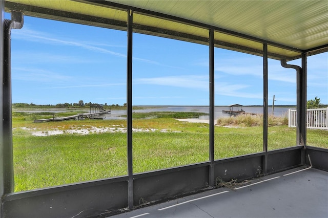 unfurnished sunroom with a water view