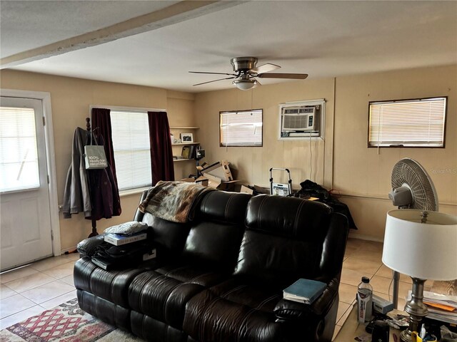 home theater featuring a ceiling fan, a wall mounted AC, and light tile patterned floors