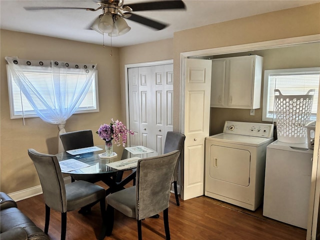 dining room featuring dark wood finished floors, a ceiling fan, and washing machine and dryer