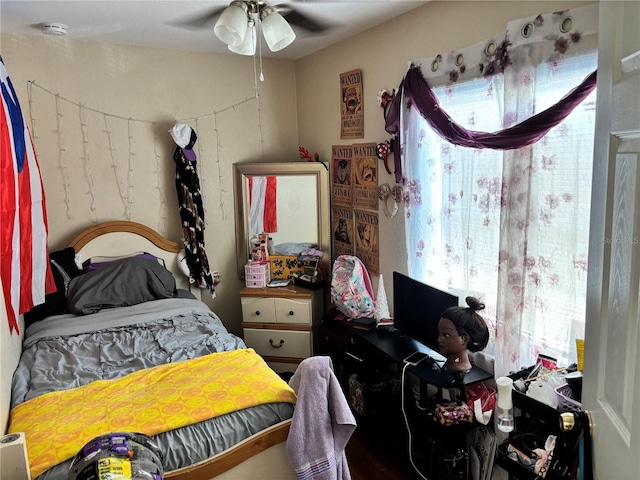 bedroom featuring ceiling fan and multiple windows