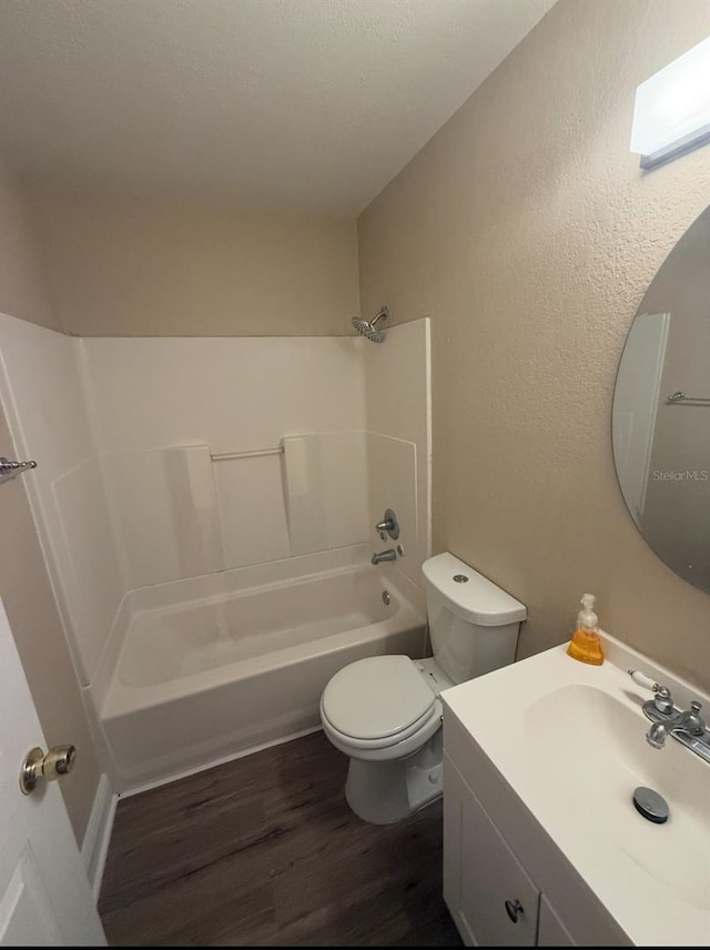bathroom featuring vanity, shower / tub combination, toilet, and wood finished floors