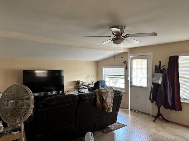 living room featuring lofted ceiling, a ceiling fan, and light tile patterned floors