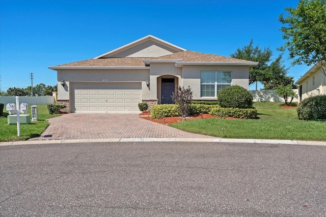 single story home with an attached garage, fence, stucco siding, and decorative driveway