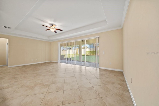 unfurnished room featuring light tile patterned floors, ceiling fan, a tray ceiling, baseboards, and visible vents