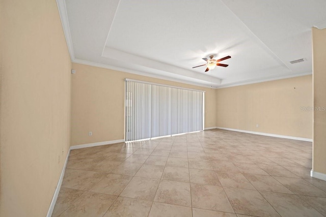 unfurnished room featuring a tray ceiling, visible vents, baseboards, a ceiling fan, and ornamental molding