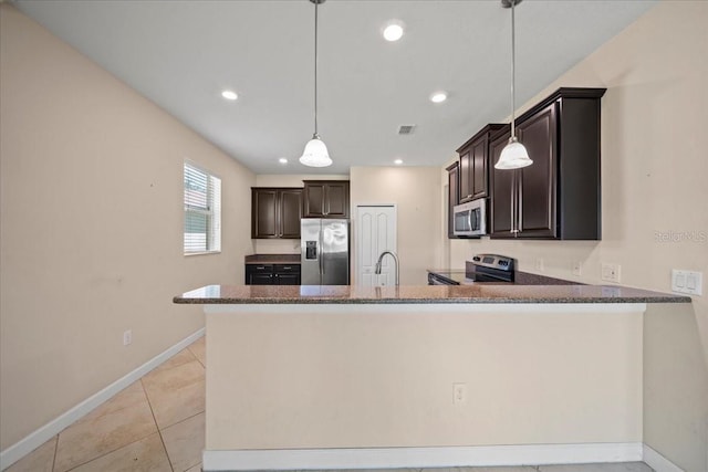 kitchen with dark brown cabinetry, stainless steel appliances, baseboards, a peninsula, and visible vents