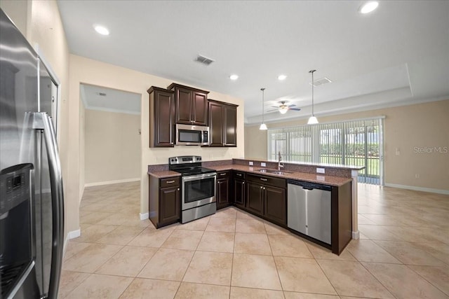 kitchen with dark brown cabinets, visible vents, appliances with stainless steel finishes, and a sink