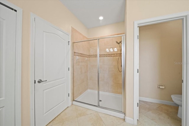 full bath featuring a shower stall, baseboards, toilet, tile patterned flooring, and recessed lighting