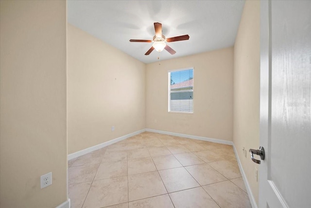 unfurnished room with baseboards, tile patterned flooring, and ceiling fan