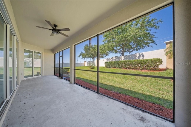 unfurnished sunroom featuring a ceiling fan