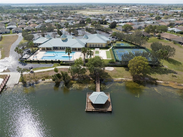 drone / aerial view featuring a water view and a residential view
