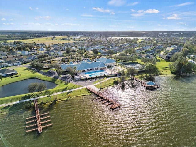 drone / aerial view featuring a residential view and a water view