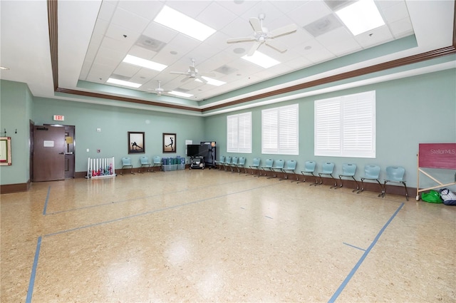 miscellaneous room featuring ceiling fan, a paneled ceiling, and a raised ceiling