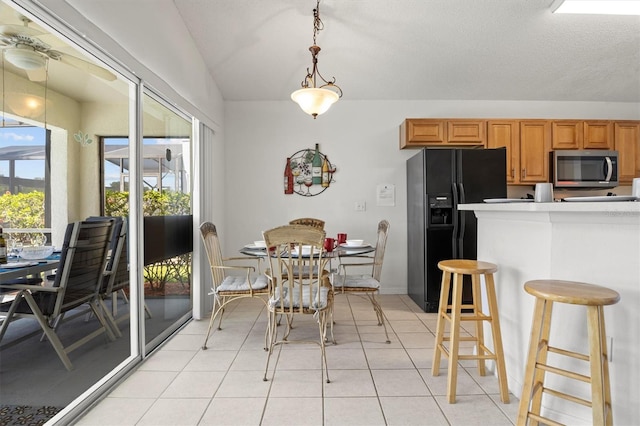 dining space featuring light tile patterned floors and a ceiling fan