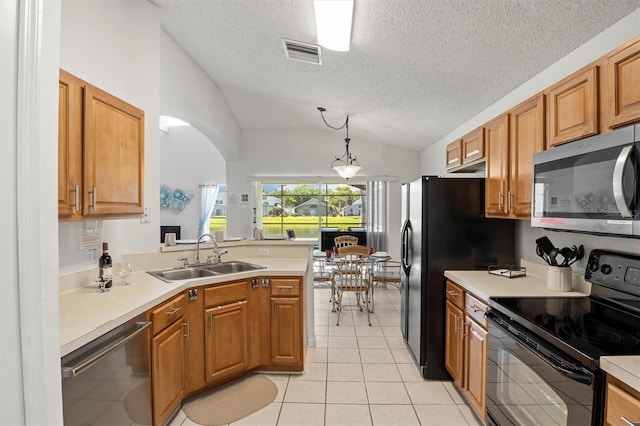 kitchen featuring visible vents, a sink, light countertops, black appliances, and lofted ceiling